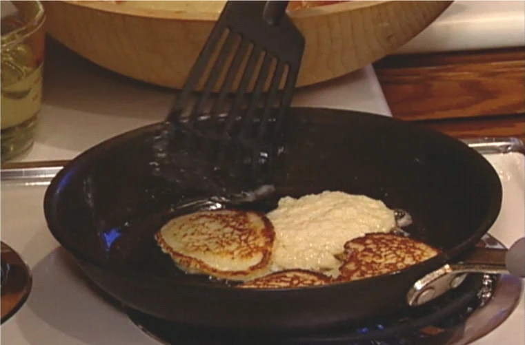 Bubbie's Latkes being cooked on a stove